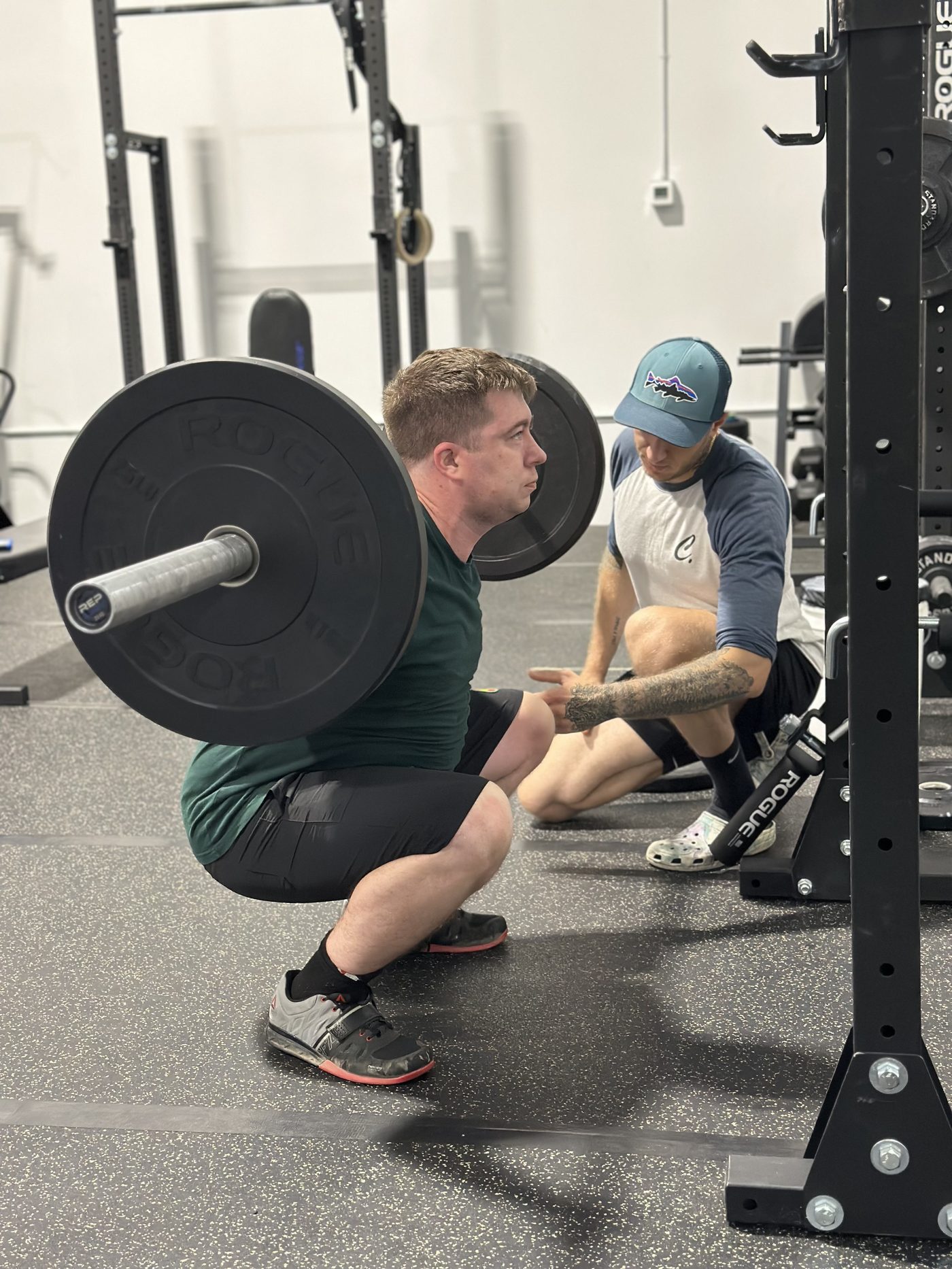 Stanislav Babenko coaching a lifter through a squat at Grizzly Weightlifting